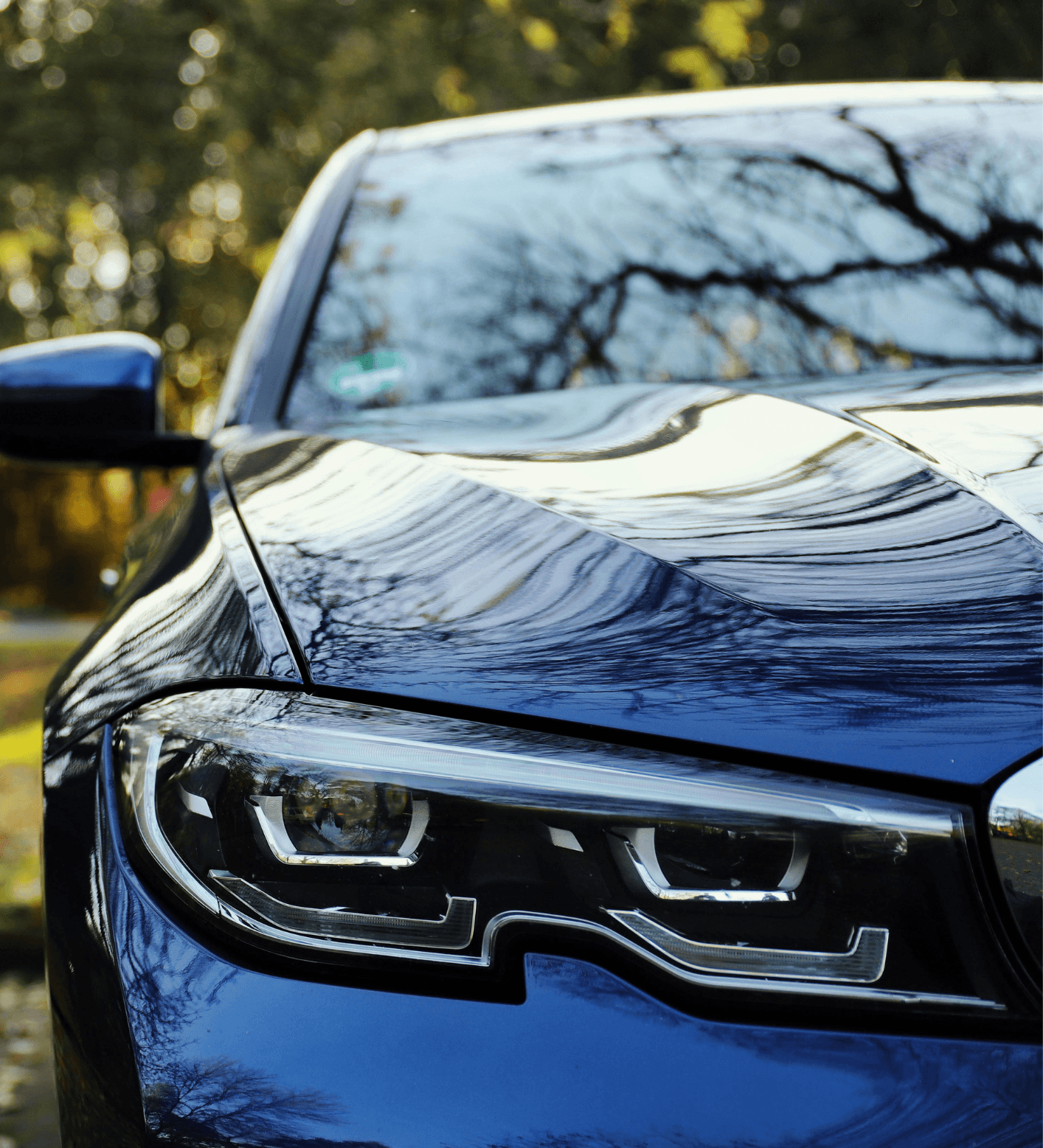 Close-up of a BMW headlight and bonnet in daylight, showcasing a premium vehicle maintained by Prestige Auto Repairs in Warrington.