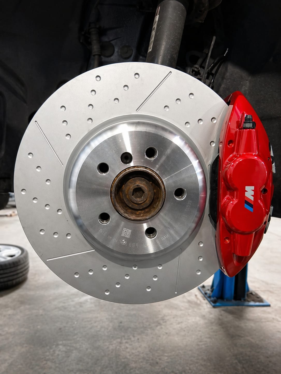 Prestige Auto Repairs Brake Repairs and Upgrades Prestige Auto Repairs brake disc and red performance brake caliper close-up